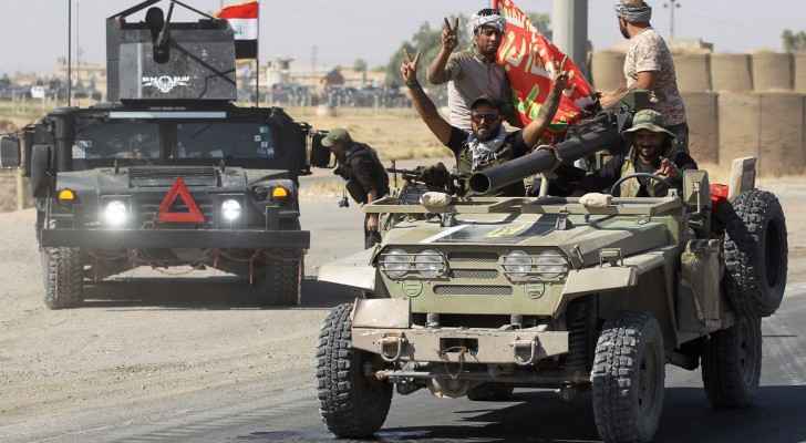 Iraqi forces flash victory signs as they advance toward Kirkuk. (NPR)