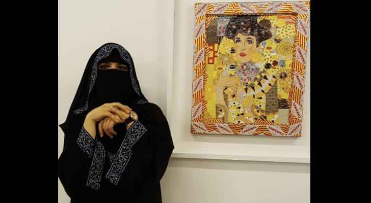 Ghada Al-Rabee poses with her artwork. (Instagram)