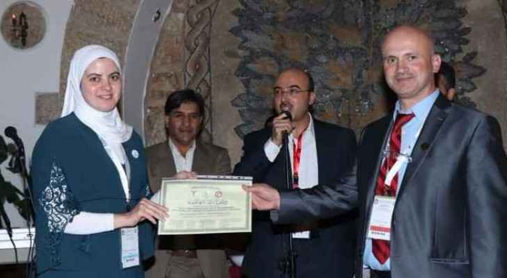 Dr. Ala' Abu Hijleh being honored by Dr. Wael Al 'izazy, head of the Jordanian Orthopedist Association