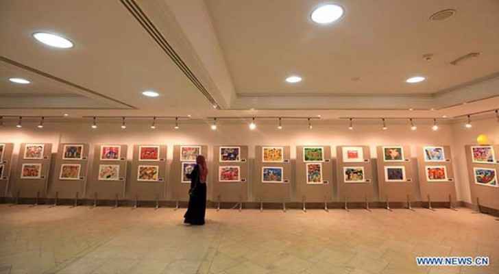 A visitor watches Chinese children's paintings at the King Abdullah Cultural Centre in Zarqa, Jordan, on Nov. 12, 2017. The activities of the Chinese 