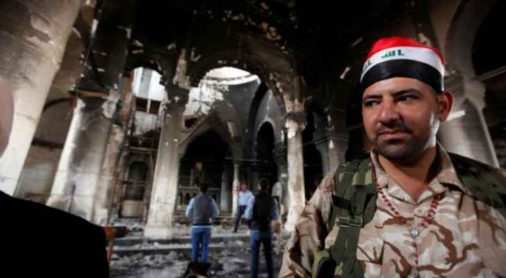 An Iraqi Christian soldier stands at the Grand Immaculate Church. (Christian Today Website)