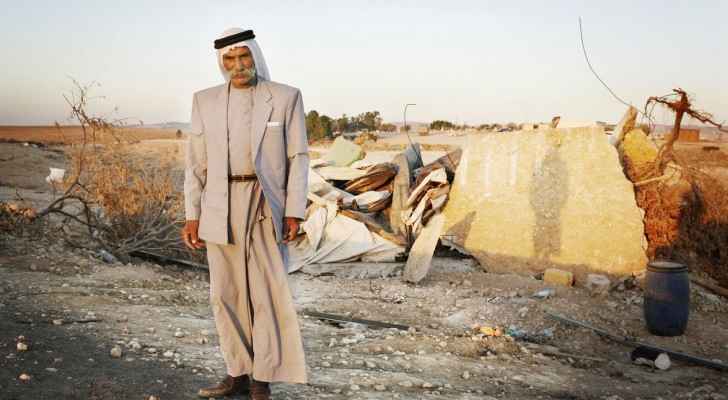 Sheikh Sayah Al-Turi, one of Al Araqib village residents in front of his demolished village. (Image from: The Institute for Middle East Understanding)