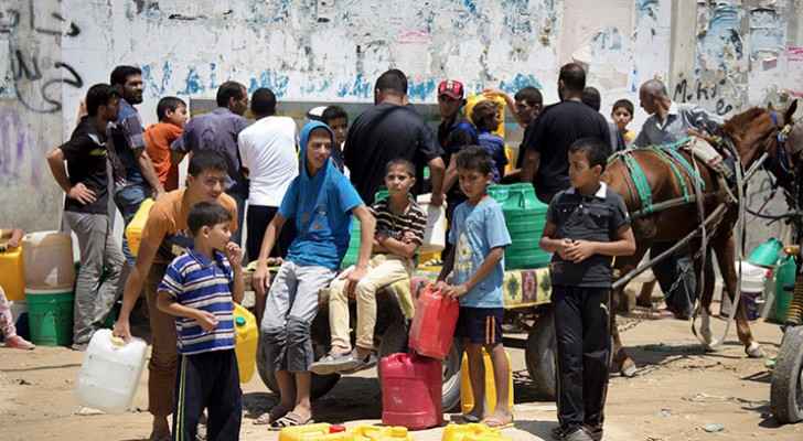 People gathering around a water well in Khan Younis, Gaza (Activestills)