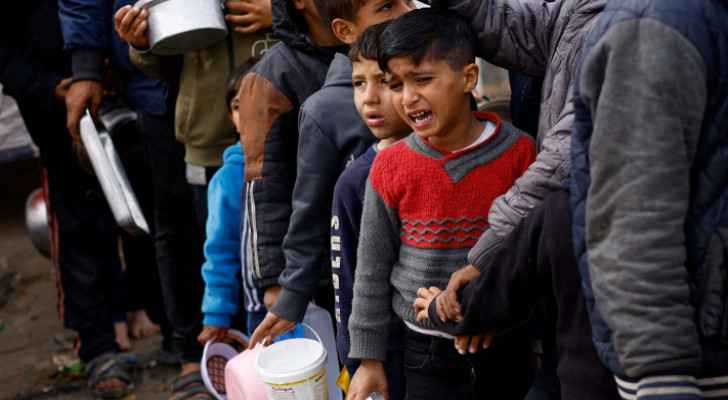 Children in Gaza lining up to receive food aid
