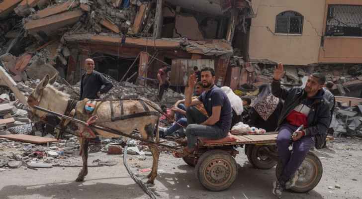 Palestinians sitting on the back of a donkey cart to commute in the city of Nuseirat in central Gaza. (April 18, 2024) (Source: AFP) 