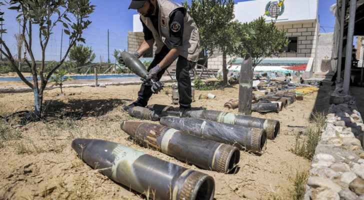 Palestinian explosives expert lays out unexploded ordnance in Khan Yunis, Gaza. (June 5, 2021) (Photo: Mahmud Hams / AFP)