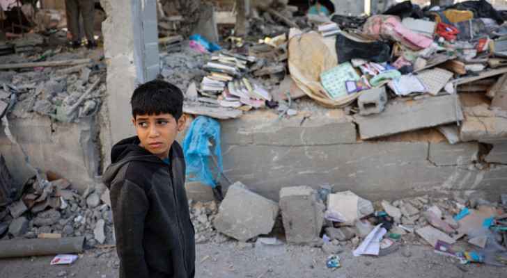 A Palestinian child stands in front of a building destroyed by “Israeli” bombing in Rafah, south Gaza. (May 3, 2024) (Photo: AFP) 