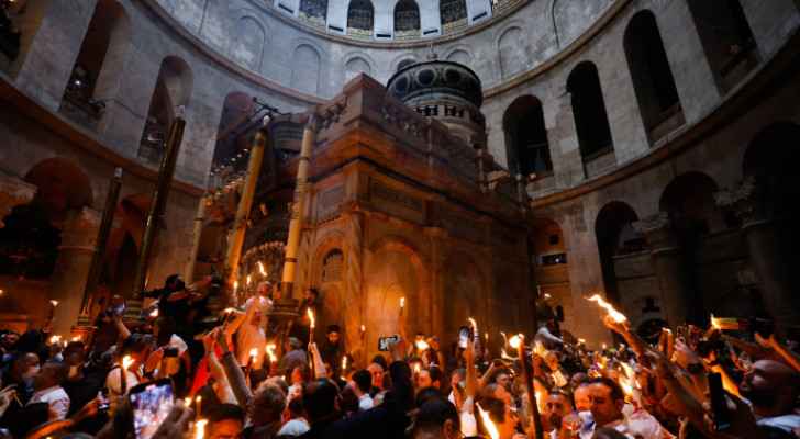 Christians pass a torch during the Holy Fire ceremony to light the candles of the Church of the Resurrection.