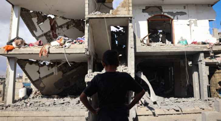 Child stands in front of a destroyed building hit by Israeli Occupation strike in Rafah, southern Gaza