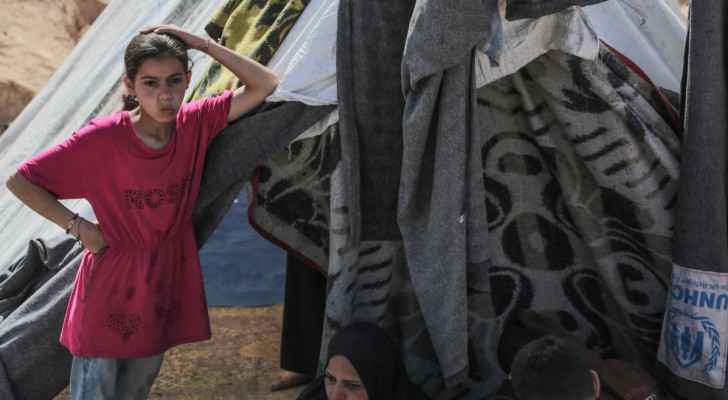 A Palestinian girl looks on amid tents at an area housing internally displaced people. (Nuseirat, central Gaza) (May 10, 2024) (Photo: AFP) 