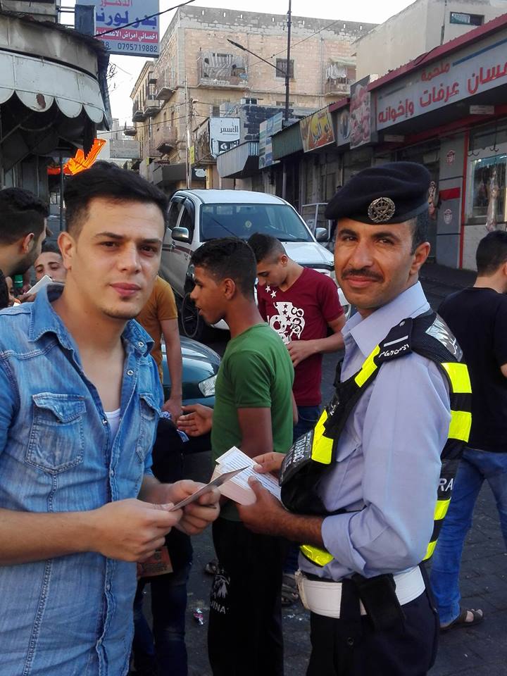Police hand out candy in Irbid. 