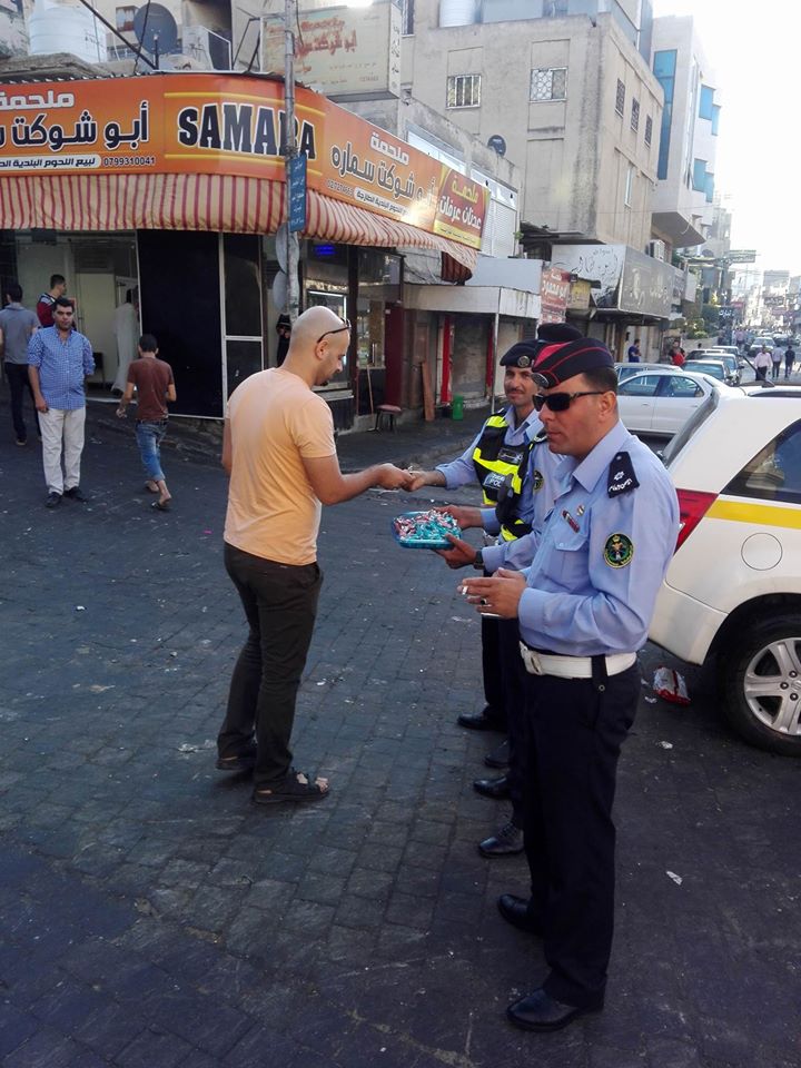 Police hand out candy in Irbid. 