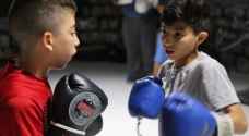Palestinian and Danish boxers touch gloves in the West bank