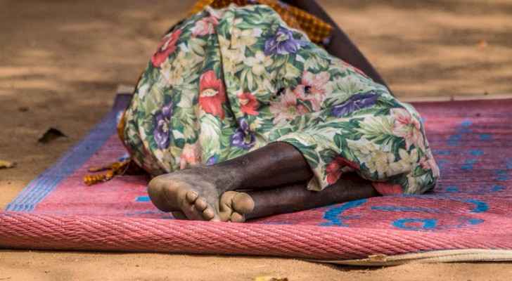 An elderly woman sleeps outside Yoyo Health Centre in Bidibidi refugee settlement, Yumbe district, northern Uganda. (Photo courtesy of Amnesty Interna