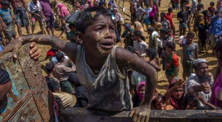 A Rohingya Muslim boy pleads with aid workers to give him a bag of rice. (Photo Credit: AP)