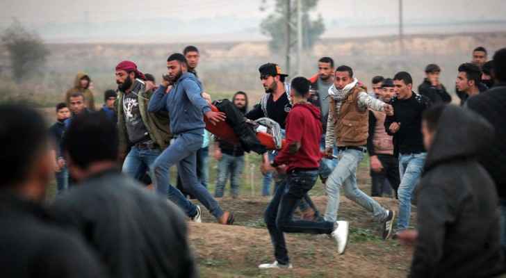 Palestinians carrying a wounded person during the Friday clashes with Israeli soldiers at the Gaza borders. One person died and at least 45 others wer
