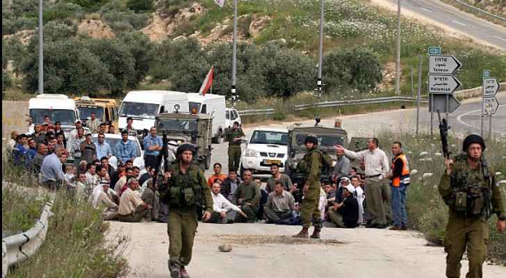 Palestinians in the village of Ras Karkar and foreign activists blocking a road in protest in Ramallah, 2007 (Getty Images)