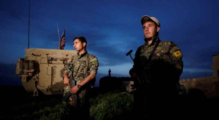 Kurdish fighters  stand near a U.S military vehicle in the town of Darbasiya near the Turkish borders (Reuters) 