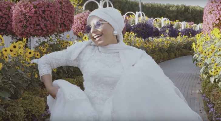Haifa runs across the Dubai Miracle Garden on her 'wedding day.' (YouTube)