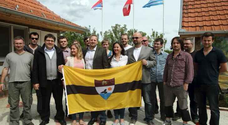 Vit Jedlicka with supports holding the flag on Liberland (24sata)
