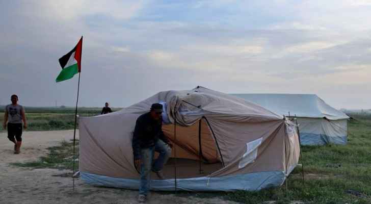 Palestinians set up tents in preparation for mass demonstrations along the Gaza strip border