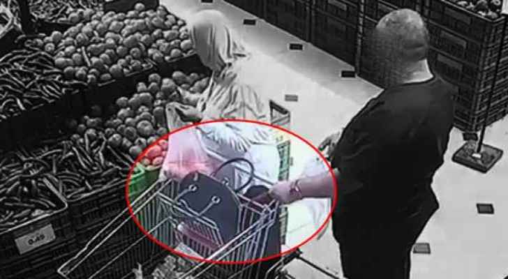Still from the video footage showing the moment of theft in a supermarket