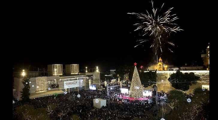 Christians celebrate the lighting of a Christmas tree in Manger Square, outside the Church of the Nativity in the West Bank town of Bethlehem, Dec. 1,