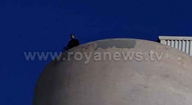 Video: Man threatens to jump off silo in Irbid