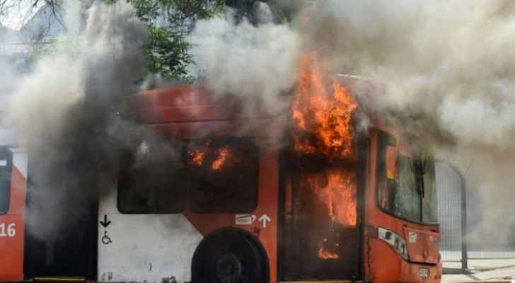 Bus set on fire by rioters  