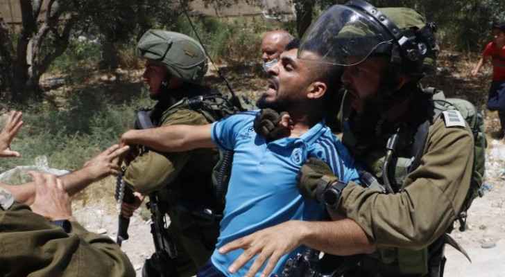 Israeli Occupation authorities assault elderly man, arrest his son