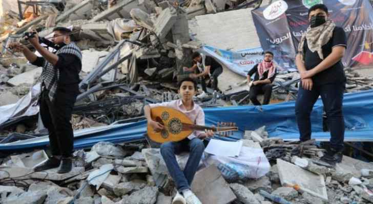 PICTURES: Young Palestinians hold musical performance on tower ruins in Gaza
