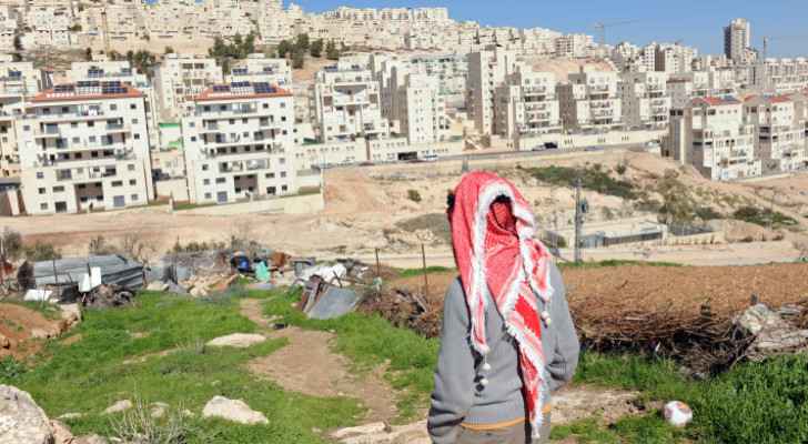 An elderly Palestinian gazes towards settlements in the West Bank