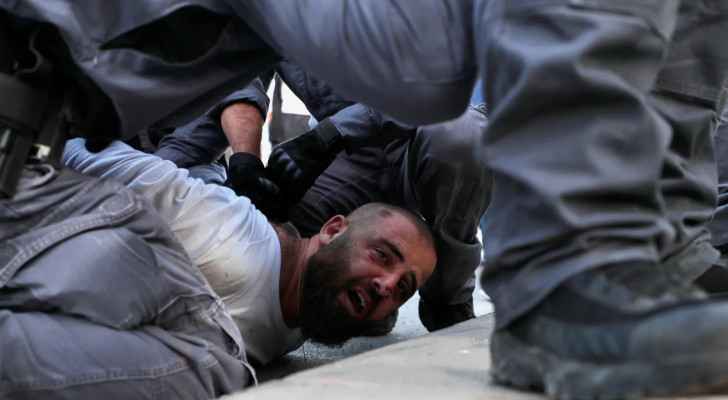 Israeli Occupation security forces arresting a Palestinian man 