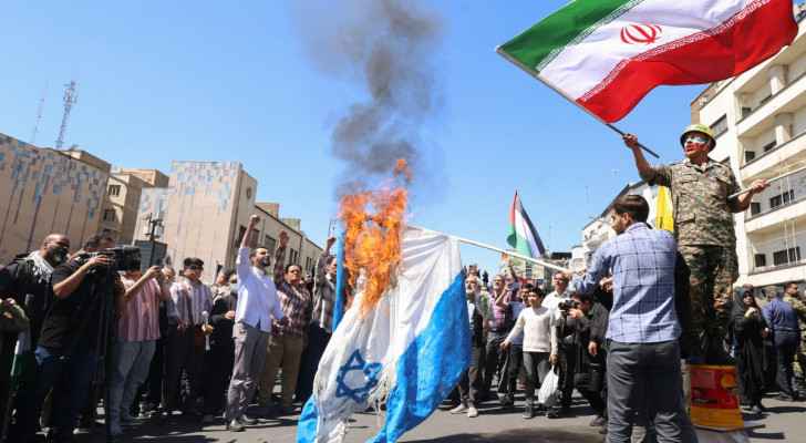 Iranians burn an “Israeli” flag during the annual Quds (Jerusalem) Day. (April 5, 2024) (Photo: AFP) 