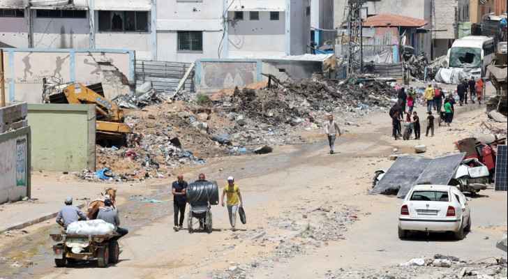 Palestinians walk among the ruins in Beit Lahiya in north Gaza. (May 4, 2024) (Photo by AFP)