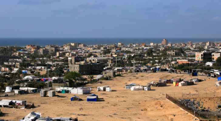 Displaced people's tents in Rafah, southern Gaza, among residential buildings.