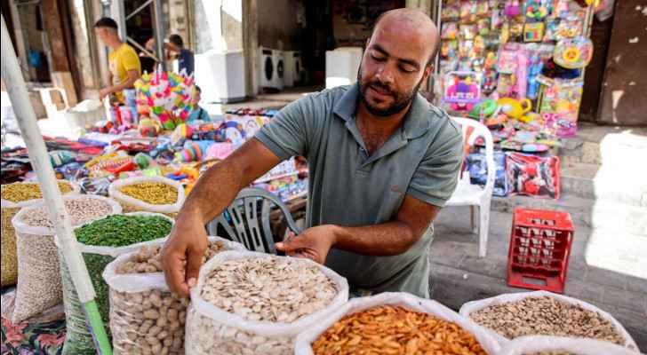 A vendor lays out his merchandise of dried fruit, nuts, and seeds at a market in Gaza City ahead of Eid al-Adha. (June 15, 2024) (Photo: AFP) 
