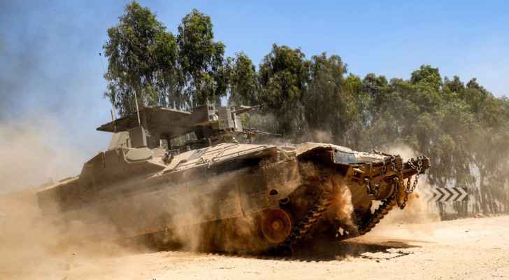 An “Israeli” army armored personnel carrier (APC) moves to take position near the border with the Gaza Strip. (July 2, 2004)